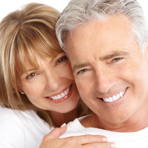 middle aged couple smiling after dentist visit