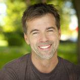 man with beautiful smile after gum treatment at dentist